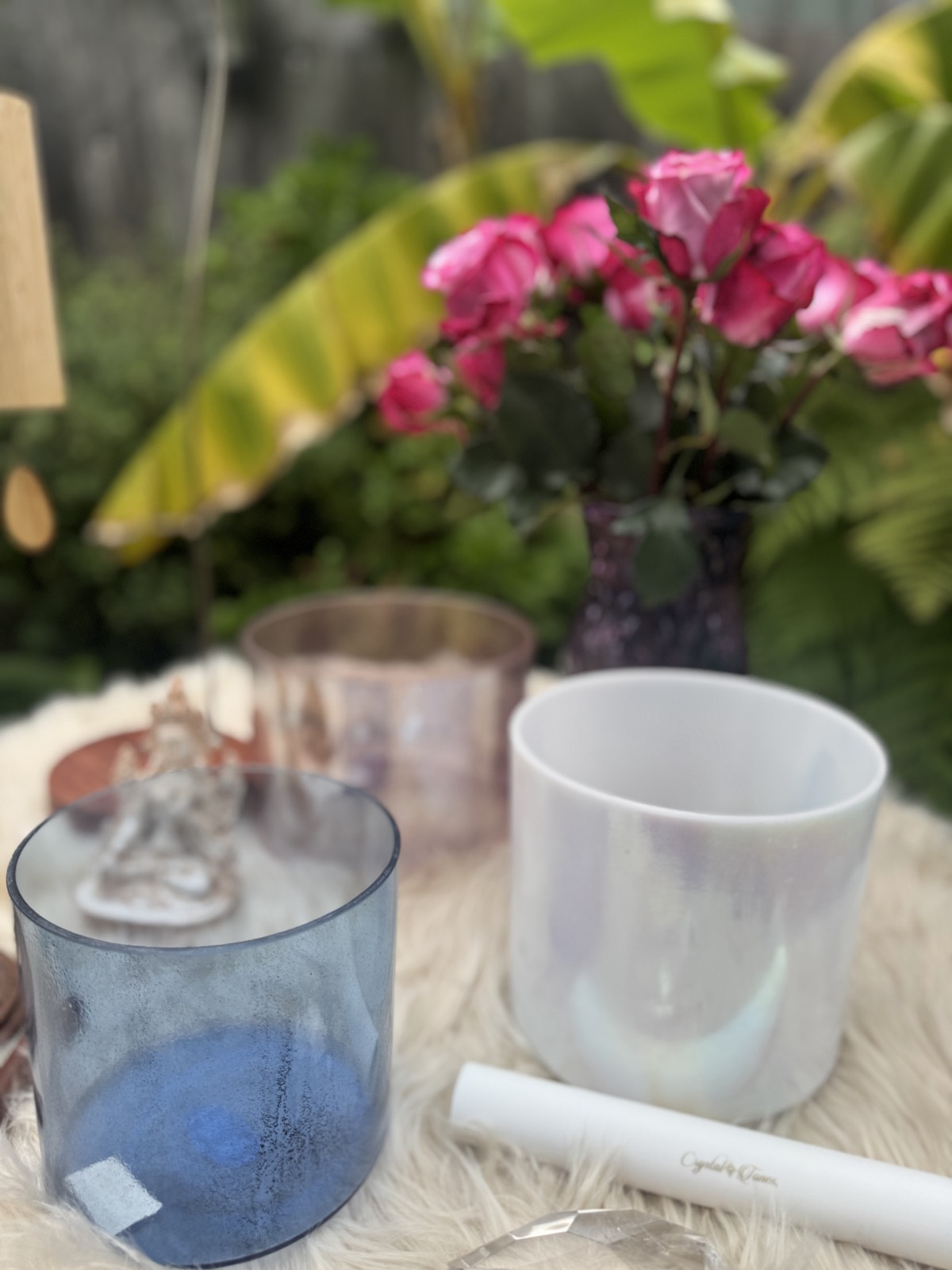 Blue and iridescent crystal singing bowls on sheepskin